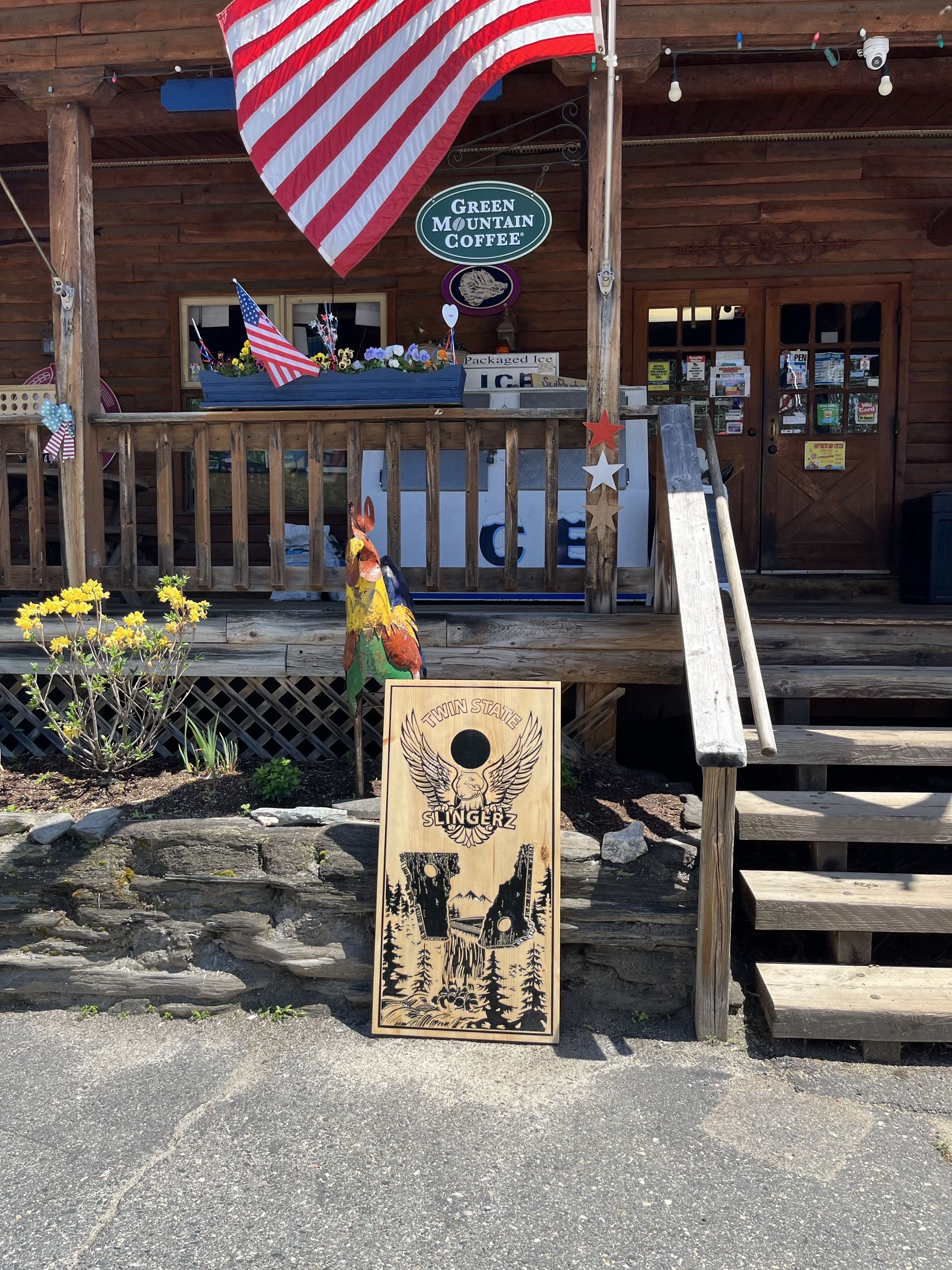 Cornhole board in front of the store with American flag
